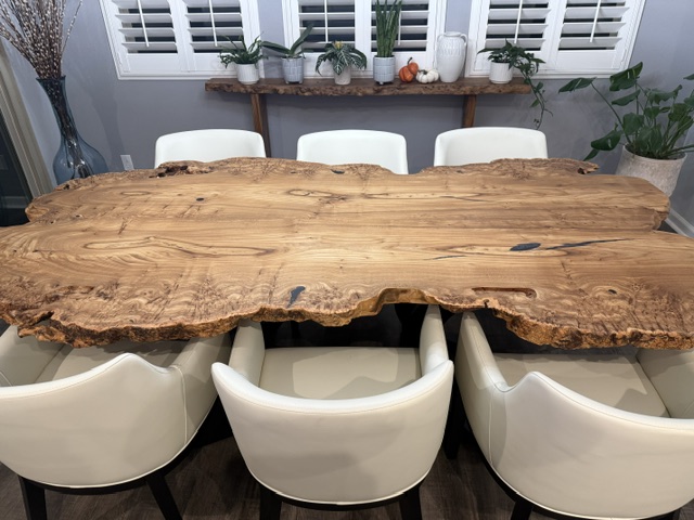 Finished live-edge dining table with chairs in a home setting