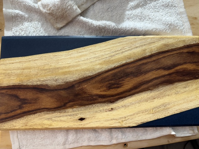 Close-up of high-contrast live-edge wood grain and resin detail