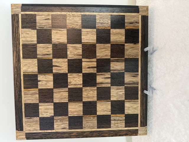Handcrafted wooden chessboard with light and dark squares