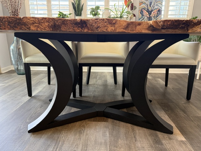 Large live-edge dining table with a modern black metal base